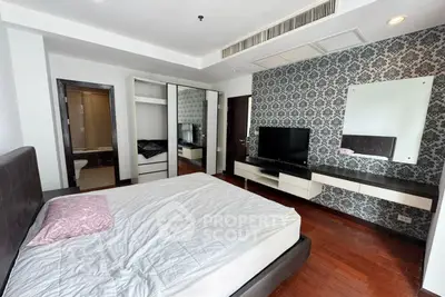 Modern bedroom with stylish wallpaper and sleek furniture in a contemporary apartment.