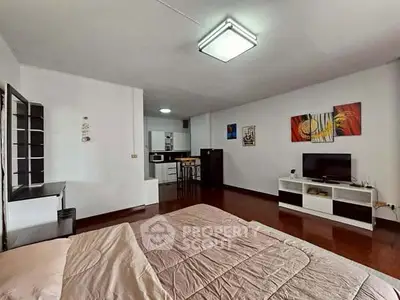Spacious studio apartment with modern decor and open kitchen layout.