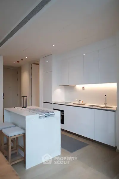 Modern kitchen with sleek white cabinets and island in a stylish apartment
