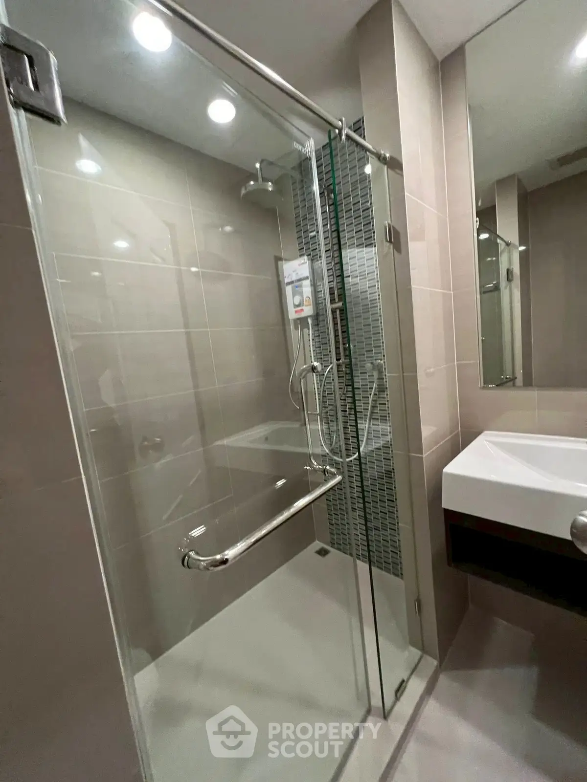 Modern bathroom with glass shower enclosure and sleek fixtures