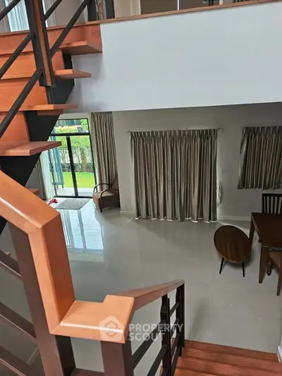 Modern duplex interior with wooden staircase and elegant dining area