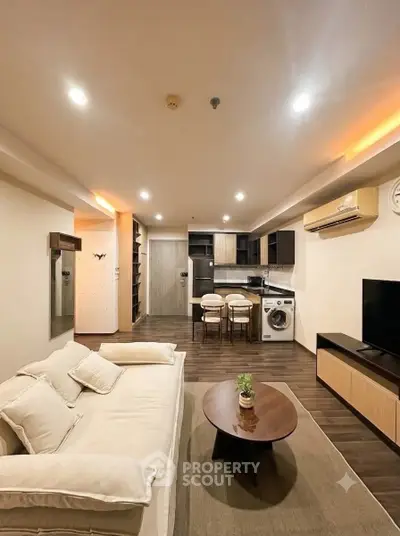 Modern living room with open kitchen and cozy seating area