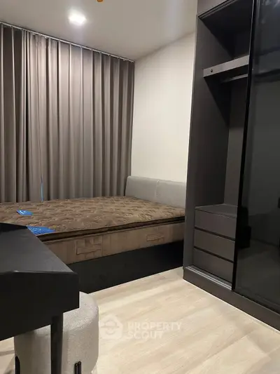 Modern bedroom with stylish furniture and elegant curtains, perfect for a cozy living experience.