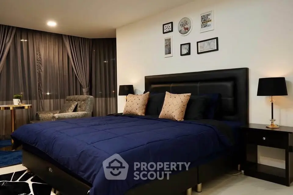 Luxurious bedroom with elegant decor and large windows offering a serene ambiance.