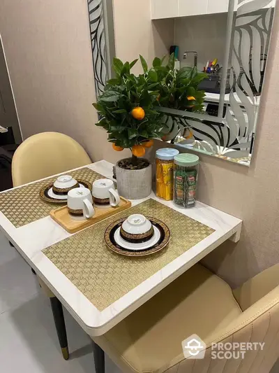 Chic dining nook with elegant table setting and decorative plant in modern apartment