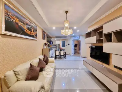 Luxurious living room with elegant chandelier and modern entertainment unit