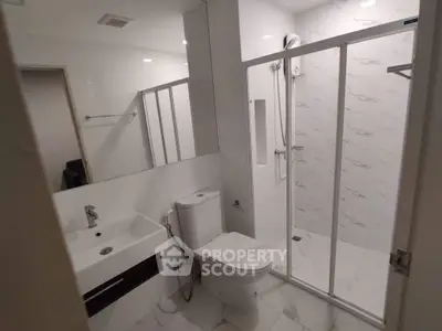 Modern bathroom with sleek shower and elegant fixtures in a contemporary home.