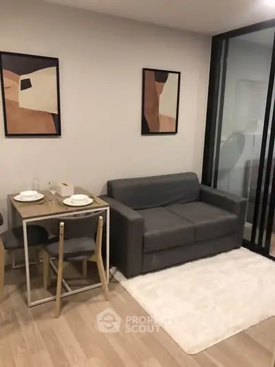 Modern living room with sleek furniture and stylish decor in a cozy apartment setting.