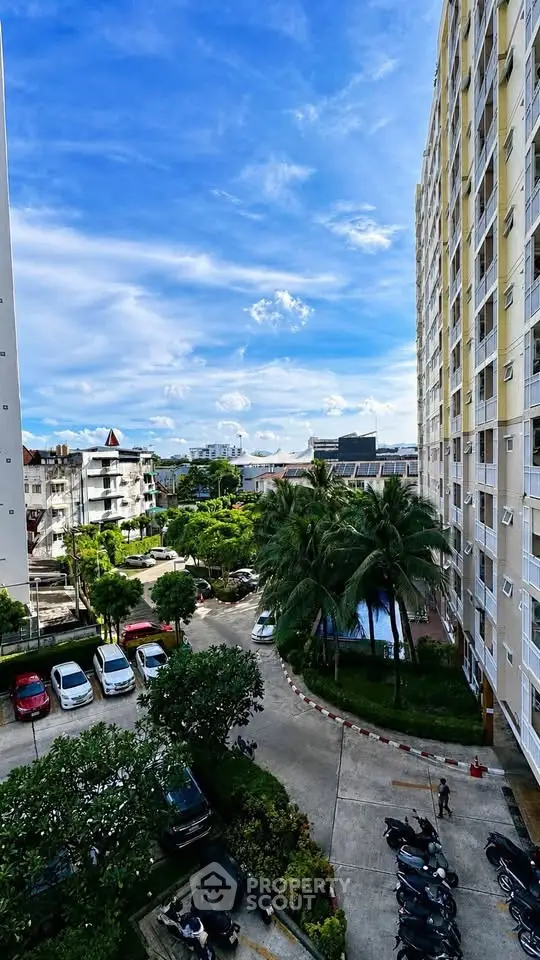 Stunning high-rise building with lush greenery and clear blue sky view.