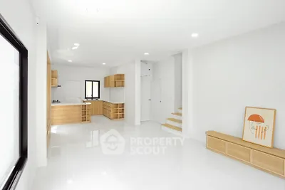 Spacious modern living room with open kitchen and minimalist design