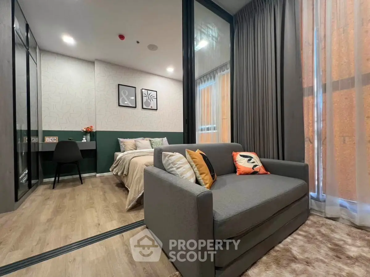 Modern studio apartment with cozy living area and stylish bedroom, featuring elegant decor and natural light.