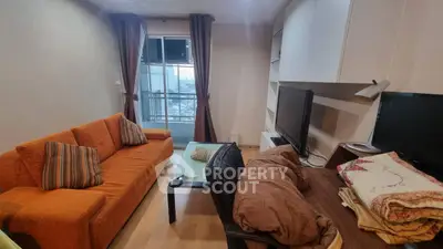 Cozy living room with orange sofa and modern entertainment setup