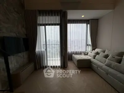 Modern living room with large windows and cozy sectional sofa