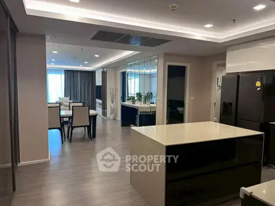 Modern open-layout kitchen and dining area with sleek design and ample natural light.