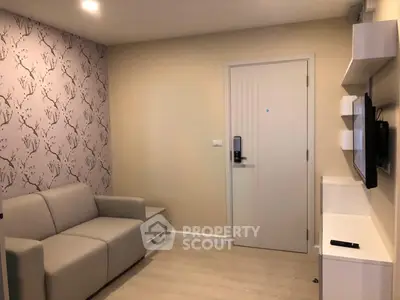 Modern living room with stylish wallpaper and cozy sofa in a contemporary apartment.