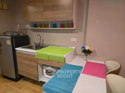 Charming kitchen with modern cabinetry and compact appliances, perfect for cozy urban living.