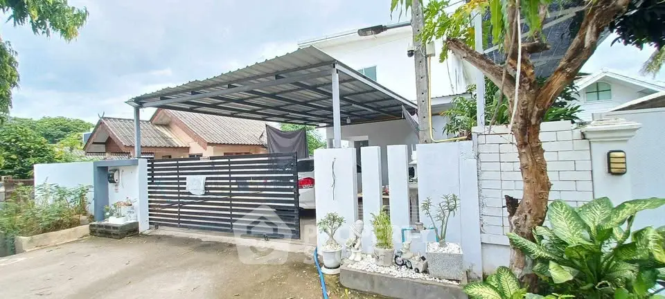 Charming suburban home with covered carport and lush greenery, perfect for family living.