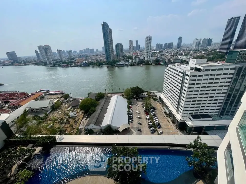 Stunning cityscape view from high-rise building with river and skyline, featuring a luxurious pool.