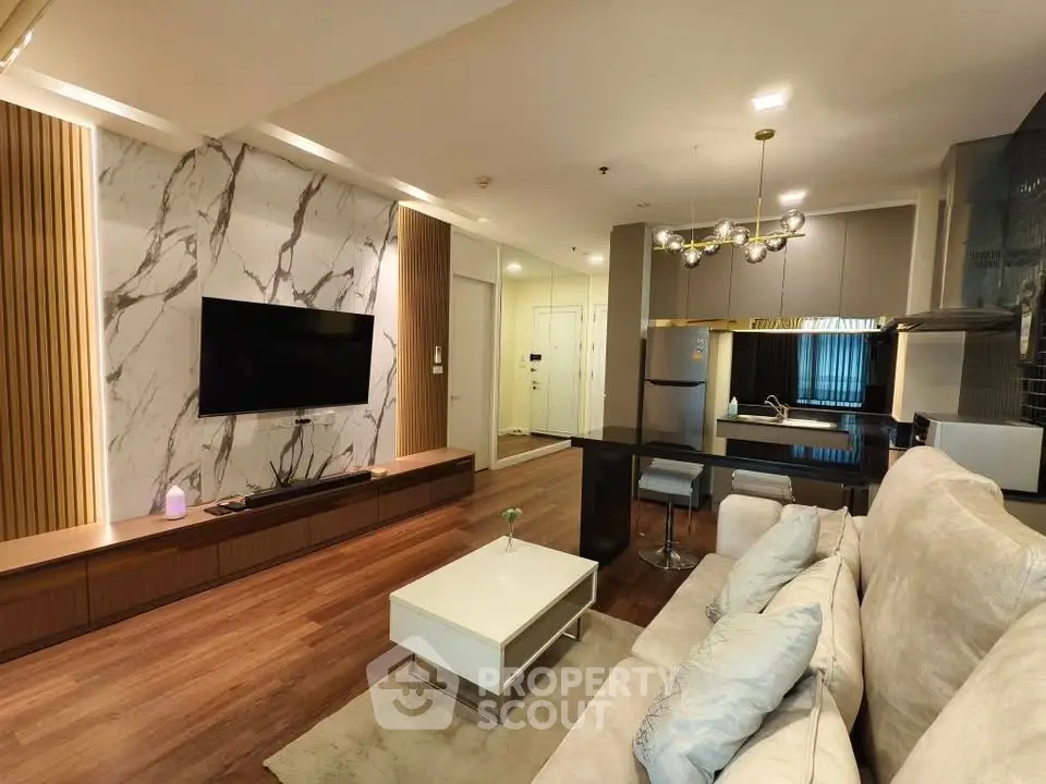 Luxurious modern living room with open kitchen, stylish decor, and elegant lighting in a contemporary apartment.