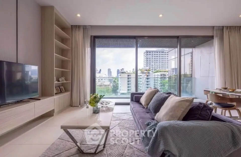 Modern living room with large windows and city view, featuring stylish furniture and elegant decor.