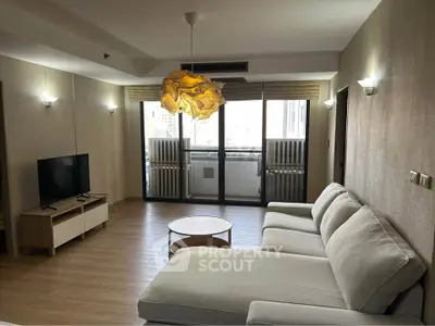 Spacious modern living room with large sofa and balcony view in a stylish apartment.