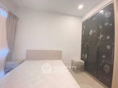 Modern bedroom with sleek black wardrobe and natural light