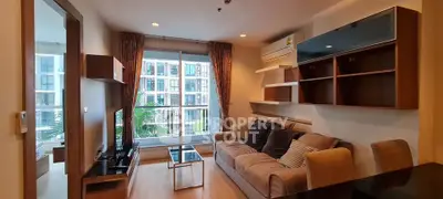 Modern living room with cozy sofa and large window offering city view in a stylish apartment.