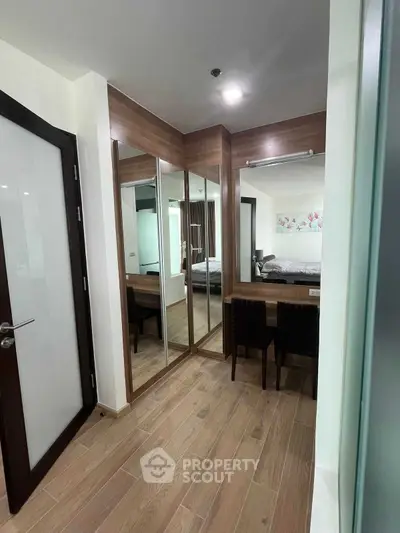 Stylish bedroom with mirrored wardrobe and elegant wooden flooring