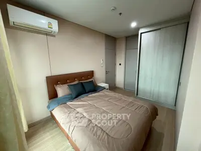 Cozy bedroom with modern decor and air conditioning in a stylish apartment.