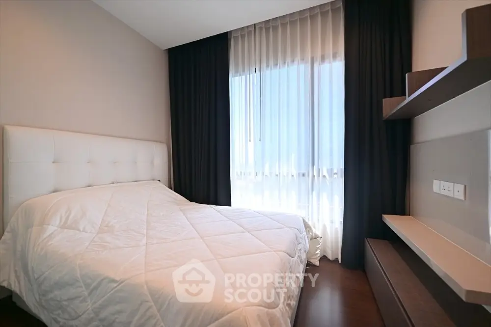 Modern bedroom with stylish decor and natural light