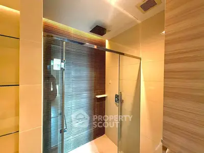 Modern bathroom with glass shower enclosure and sleek tile design