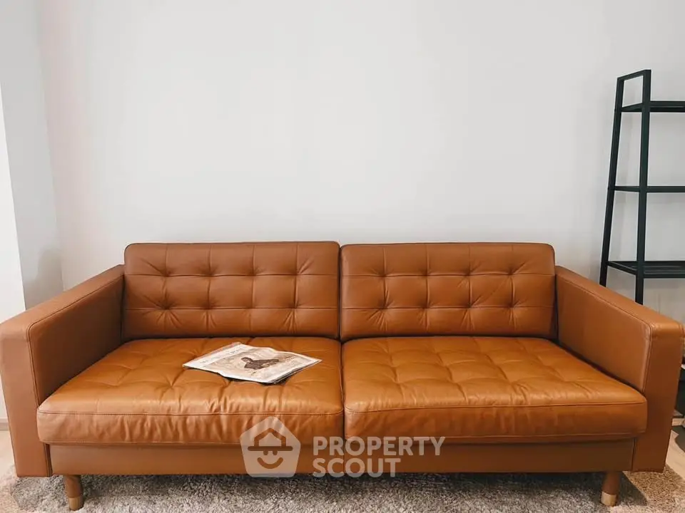 Stylish brown leather sofa in modern living room with minimalist decor.