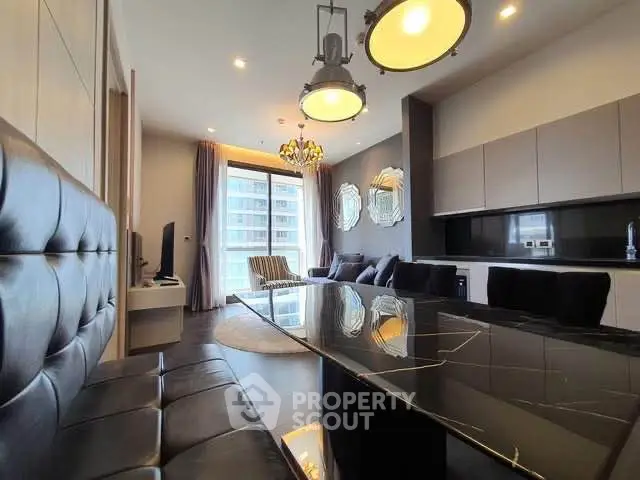 Luxurious modern living room with sleek black furniture and large windows offering city views.