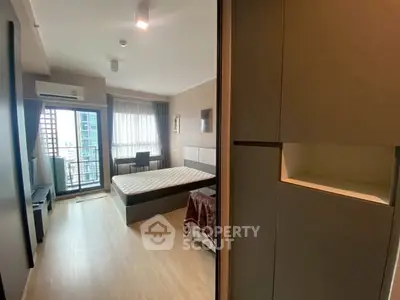 Spacious modern bedroom with balcony and natural light in urban apartment