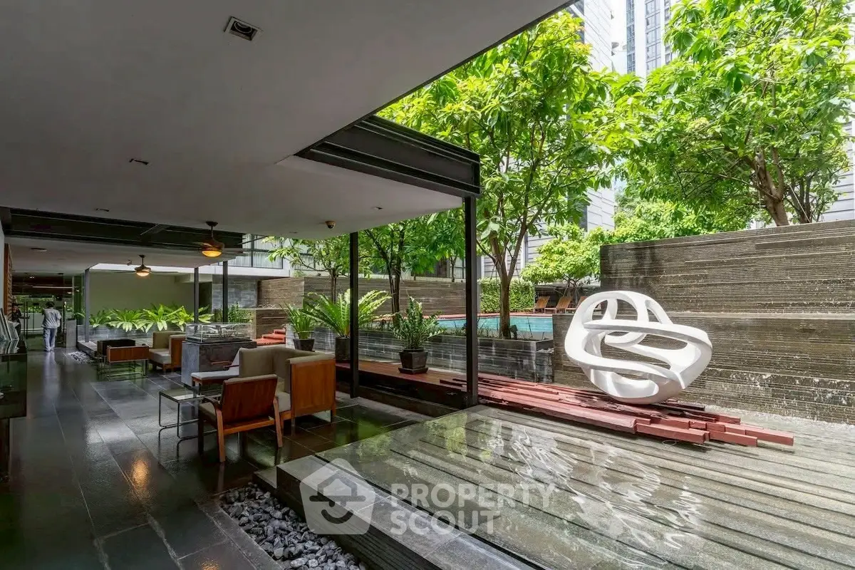 Luxurious modern outdoor area with stylish seating and lush greenery, perfect for relaxation and entertainment.