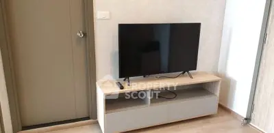 Modern living room with sleek TV stand and flat-screen television, perfect for entertainment.