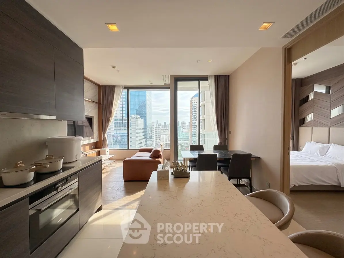 Modern open-plan kitchen and living room with city view and adjacent bedroom