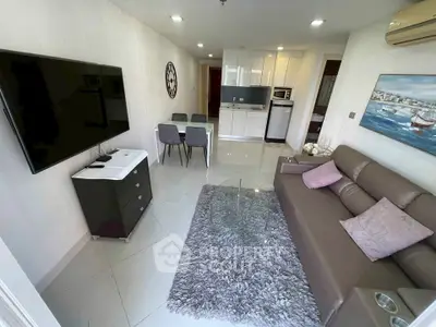 Modern living room with sleek furniture and open kitchen layout