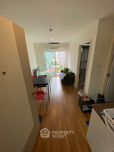 Modern apartment interior with open living area and balcony view