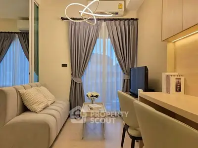 Cozy living room with modern decor, featuring a plush sofa, elegant curtains, and a sleek TV setup.