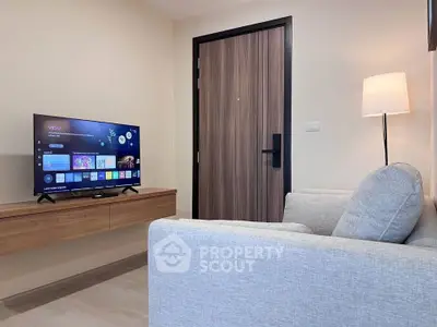 Modern living room with sleek TV setup and cozy gray sofa