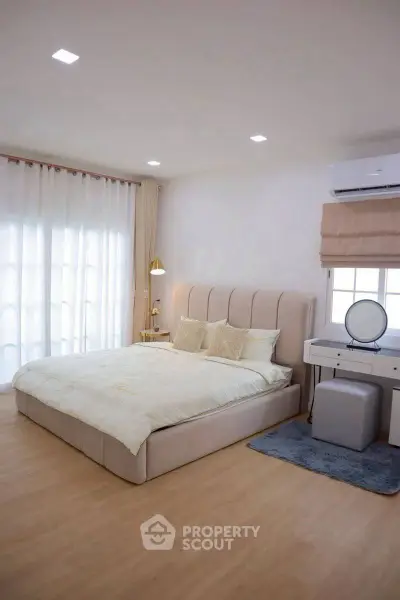 Spacious modern bedroom with elegant decor and natural light