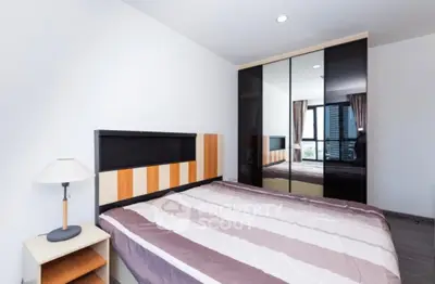 Modern bedroom with stylish wardrobe and large window view