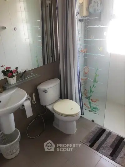 Modern bathroom with glass shower and elegant fixtures, perfect for a cozy home.
