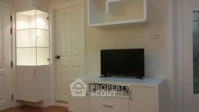 Modern living room with sleek white furniture and built-in shelving