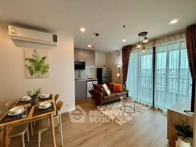 Modern open-plan living room with kitchen, featuring stylish decor and balcony access.