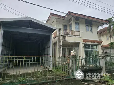 Charming two-story house with adjacent covered parking in a suburban neighborhood.