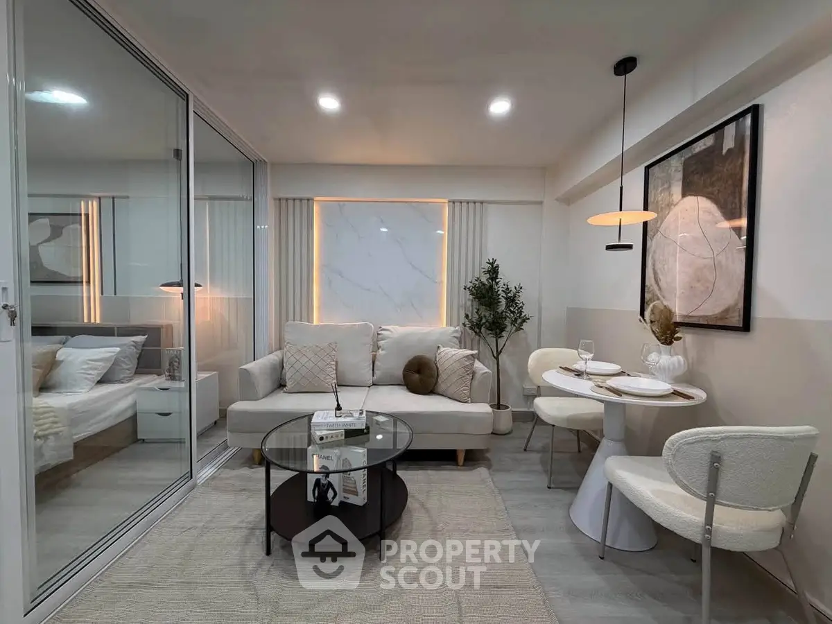 Modern living room with elegant decor and dining area in open layout apartment.