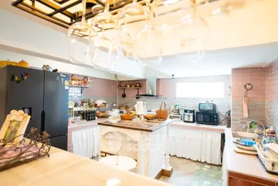 Charming kitchen with rustic decor and modern appliances, featuring an open layout and elegant glassware display.