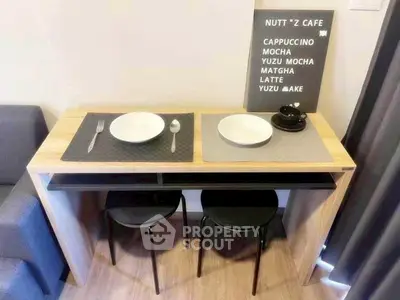 Modern compact dining area with stylish table and chairs in cozy apartment setting.